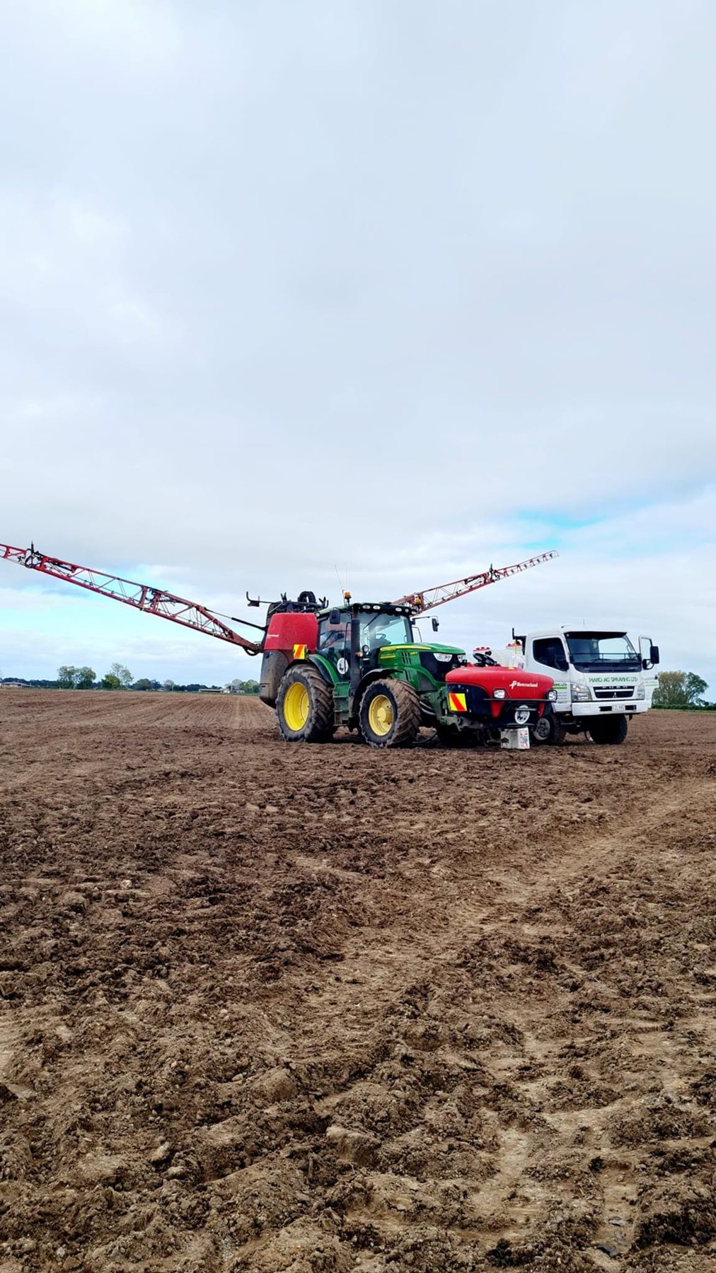 Sprayer booms folding beside the spray truck