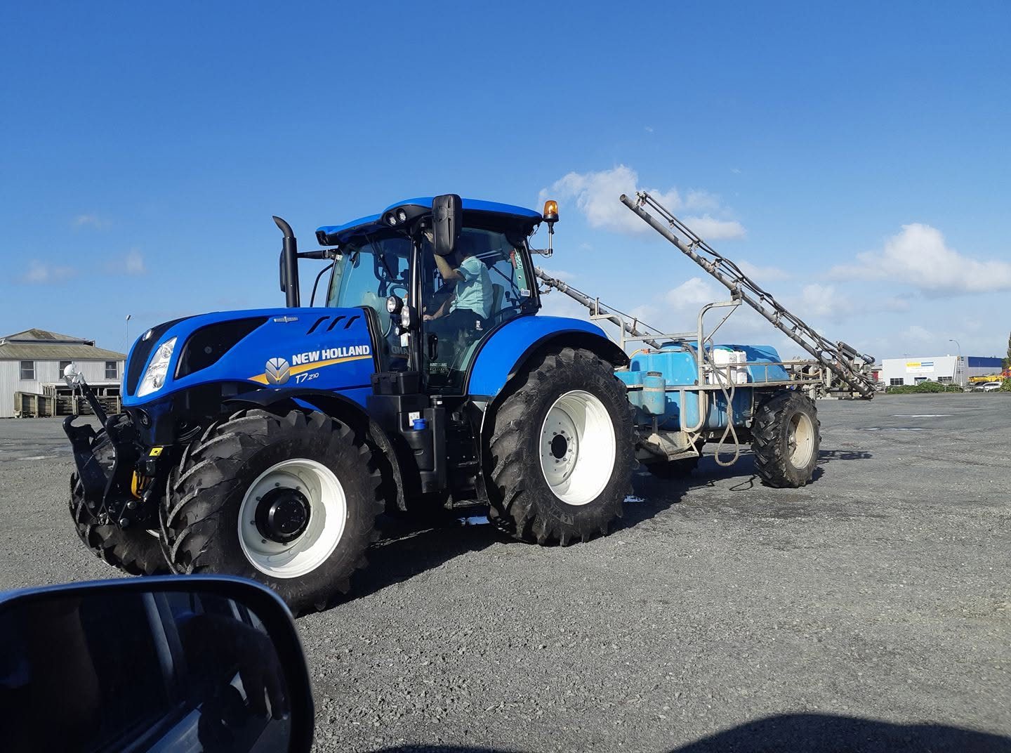 New Holland T7 with a boom sprayer